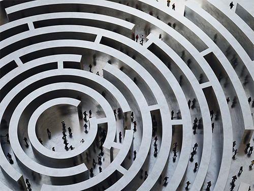 People walk in a complicated circular maze